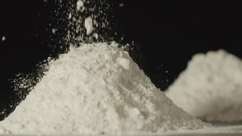 SLOW MOTION: Flour Powder Pouring Onto A Table - Close Up