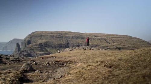 Cliffside Vista: Lone Hiker Enjoying Ocean View