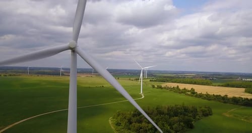 Aerial of a field of wind turbines generating renewable energy on a wind farm
