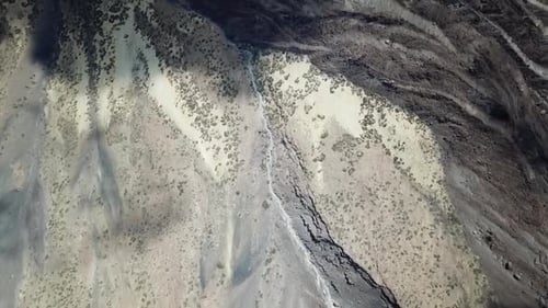 Overhead aerial drone clip over a mountainous barren volcanic area / 6 Full Hd