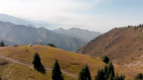 Green Camping Tent in the Mountain Forest