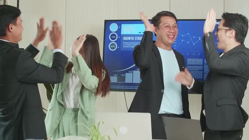 Excited Business Team Celebrates Success in Office