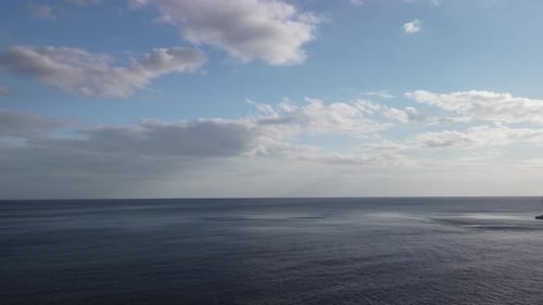 Aerial View From Above on Calm Azure Sea and Volcanic Rocky Shores