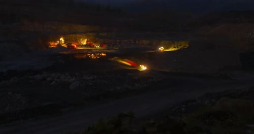 Construction Vehicles Moving at Night
