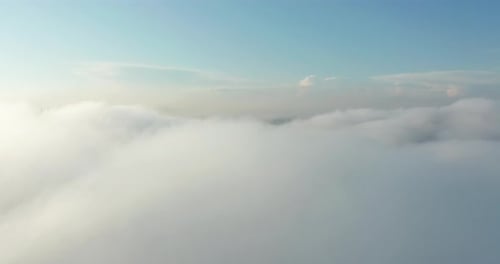 Aerial View Above Clouds Reveals Distant City