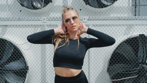 Stylish Woman Posing Confidently in Urban Setting