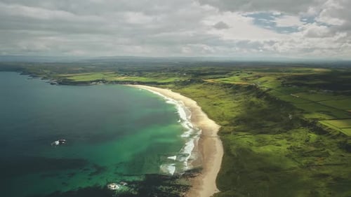 Aerial View Sandy Coastline, Green Grass Meadows. Waves Crashing Out of Shore Atlantic Ocean Bay