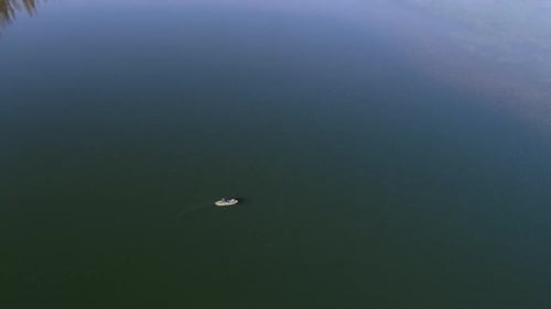 Aerial view tilting up past person on kayak to view the horizon