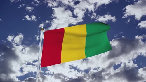 Realistic Waving Flag of Guinea Against Blue Sky