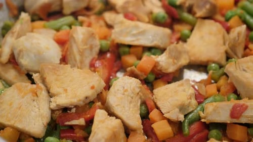Green beans and carrot with poultry in wok close-up 4K 2160p 30fps UltraHD tilting video - Fresh chi
