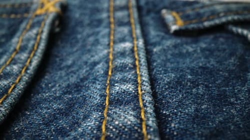 Detailed Close-Up of Blue Denim Fabric and Stitching