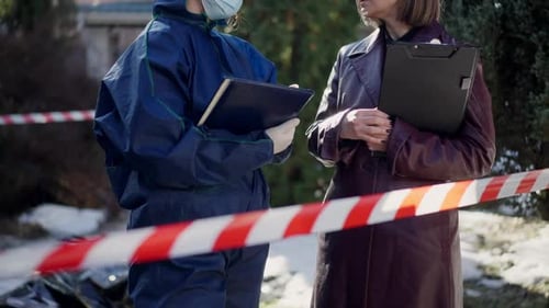 Investigator and Hazmat Suit near Crime Scene Tape