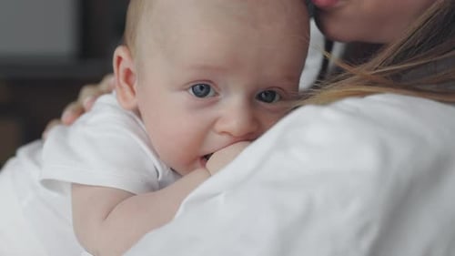 Close Up of Newborn Boy Leaning on Mothers Shoulder