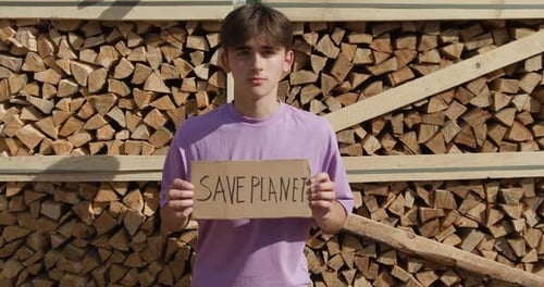 Young Adult Holding Save Planet Sign