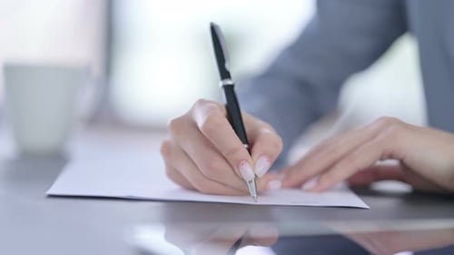 Close Up of Hands of Female Writing on Paper