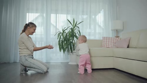 Mother Encouraging Her Baby to Walk at Home