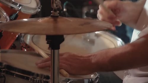 Drummer Plays Percussion Instruments at a Concert
