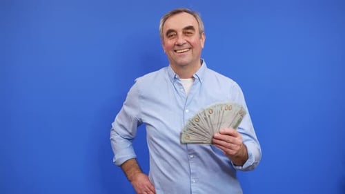 Man Smiles Holding Hundred Dollar Bills