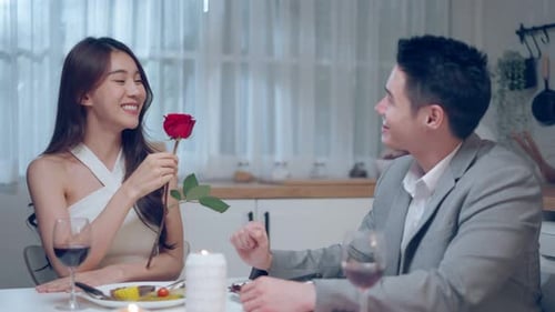 Romantic Couple Dining at Home with Rose Gift