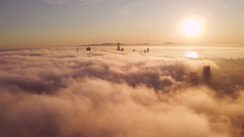 Golden Sunrise Over Cloud Shrouded City