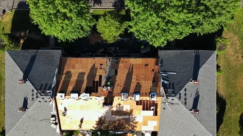 Workers Repairing Roof of Building Aerial Shot