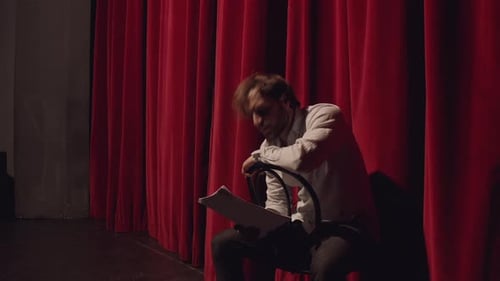 Actor in a theatre reviewing the script