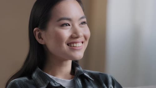 Young Woman Smiling Indoors in a Close Up Shot