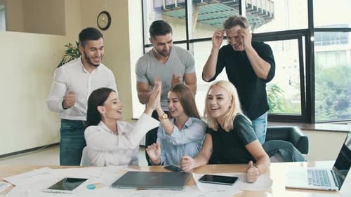 Colleagues Celebrate Success Together at Workplace