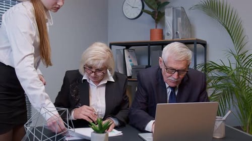 Elderly Man Boss with Woman Colleague Working in Office Developing New Project on Laptop Team Work