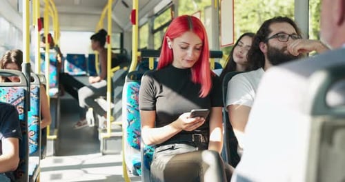 Diverse people riding bus using technology