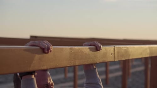 Man Does Pull Ups at Beach Sunrise