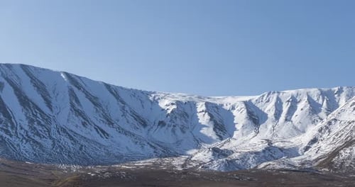 Timelapse of Sun Movement on Crystal Clear Sky Over Snow Mountain Top