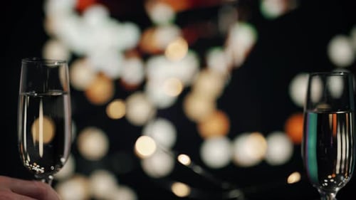Clinking Champagne Glasses with Festive Bokeh Background