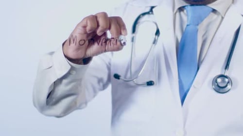 Doctor Writes the Word Motivation on Glass