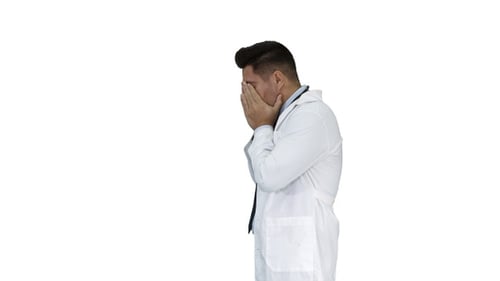 Frustrated Doctor Covers Face in Despair