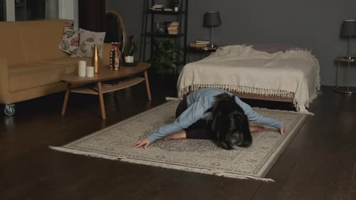 Woman Stretching Into Splits on Yoga Mat