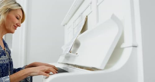 Woman Plays a Piano at Home