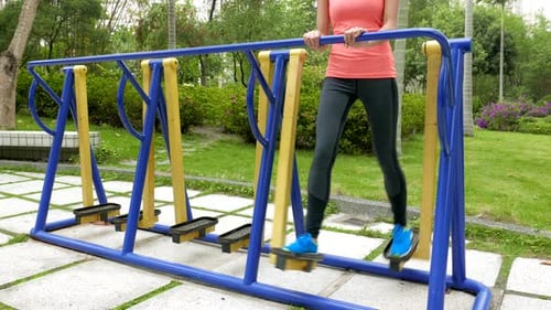 Woman Exercising on Walking Simulator in Park