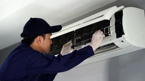 technician service removing air filter of the air conditioner for cleaning