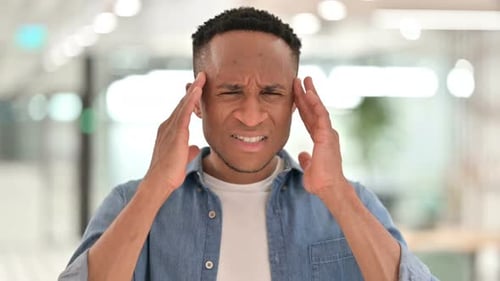 Man Massaging Temples Suffering Terrible Headache