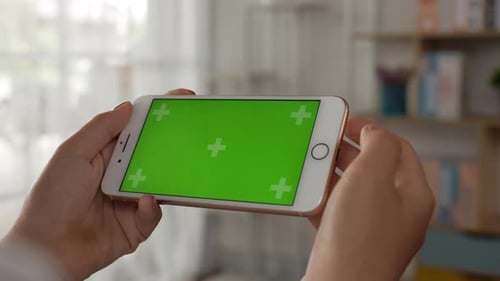 Closeup horizontal of hand woman using smartphone with green screen