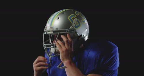Football Player Adjusts Helmet Before the Game
