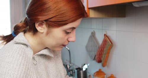 Woman Prepares Food in Kitchen Close Up