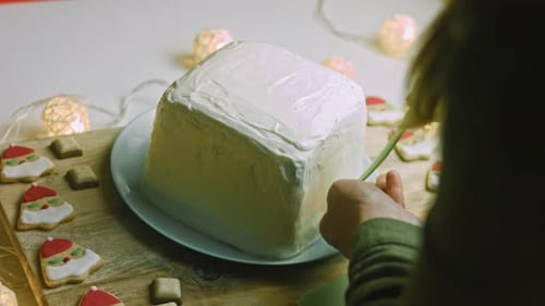 Decorating a Christmas Cake with Festive Green Ribbon