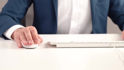 Office worker using keyboard and mouse.