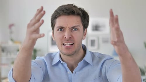 Angry Young Man Arguing and Yelling Indoors