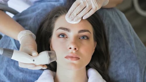 Woman Receiving Facial Treatment in a Medical Spa
