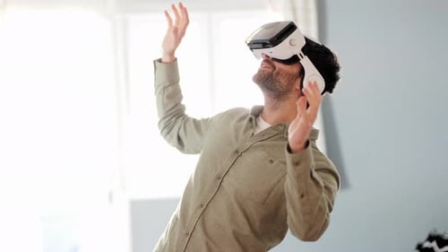 Young man exploring cyberspace in VR goggles at home