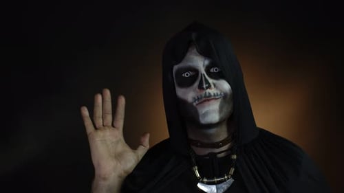 Frightening Man in Skeleton Halloween Costume Waving Hands Looking at Camera. Hi, Hello, Greeting