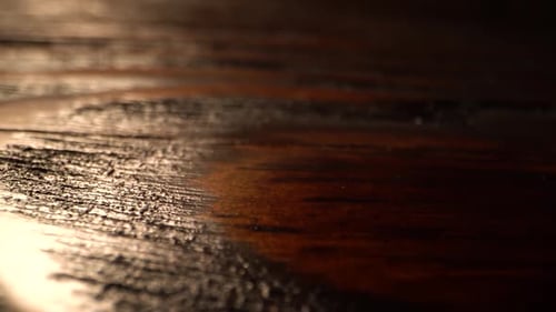 Macro Flat Wooden Surface Tracking. Vertical Sliding Camera Moving Along a Brown Textured Table with